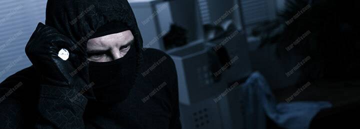masked burglar with flashlight