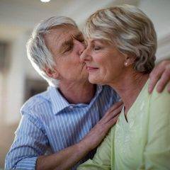 senior man kissing senior woman
