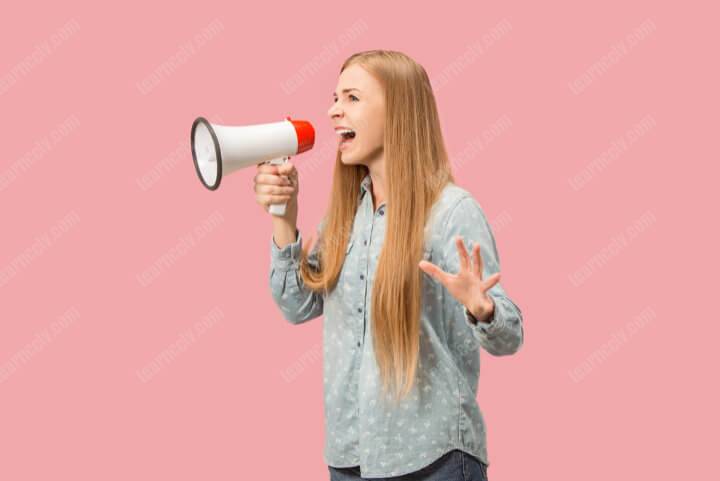 woman making announcement with megaphone