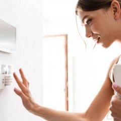 Young woman resets the ADT alarm system