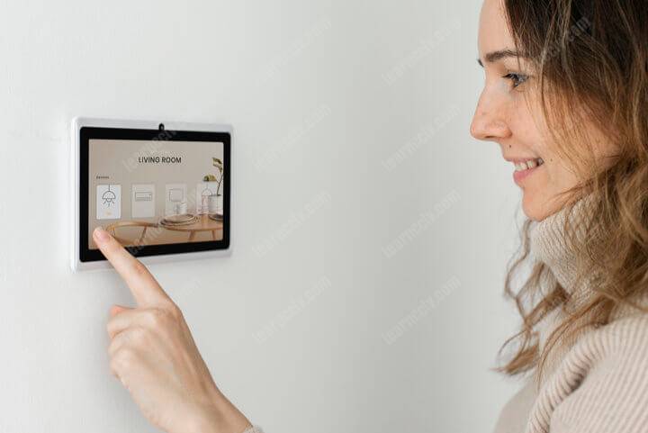Woman pressing alarm panel buttons